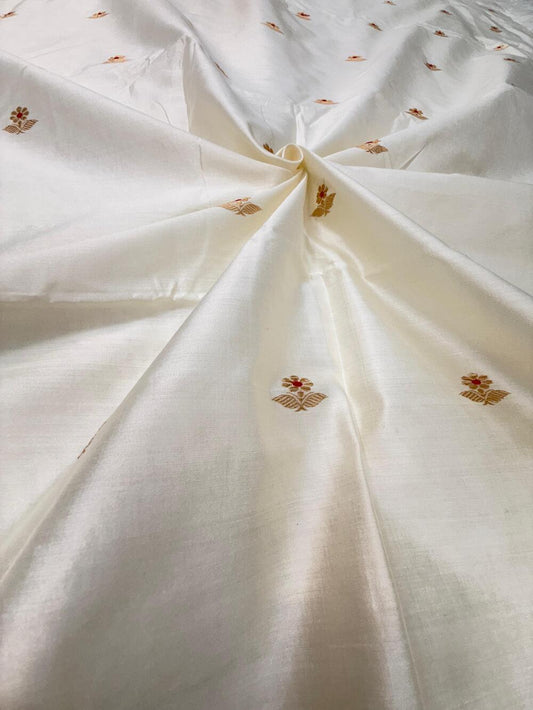 HANDLOOM CHINIYA SILK FABRIC – IVORY CREAM (KADHUWA BOOTA, GOLDEN ZARI WITH MEENAKARI, DYEABLE – PER METER)